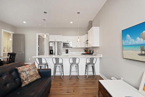 a living room with a couch and a kitchen at Gin Fizz by Pristine Properties Vacation Rentals in Port Saint Joe