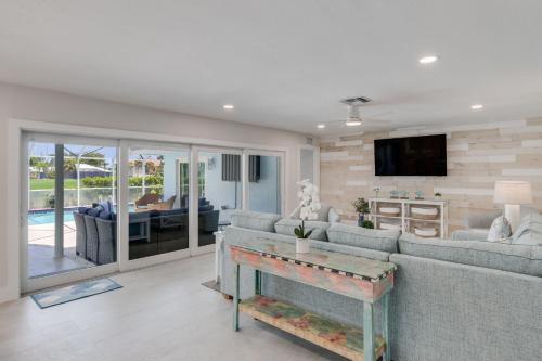 a living room with a couch and a tv at Casa Del Mar- Stunning Villa with Pool and Spa in Sanibel