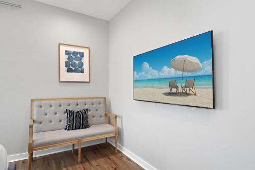 a room with a couch and an umbrella on a beach at Gin Fizz by Pristine Properties Vacation Rentals in Port Saint Joe