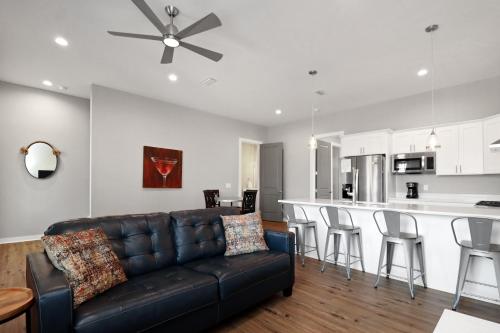 a living room with a couch and a kitchen at Gin Fizz by Pristine Properties Vacation Rentals in Port Saint Joe