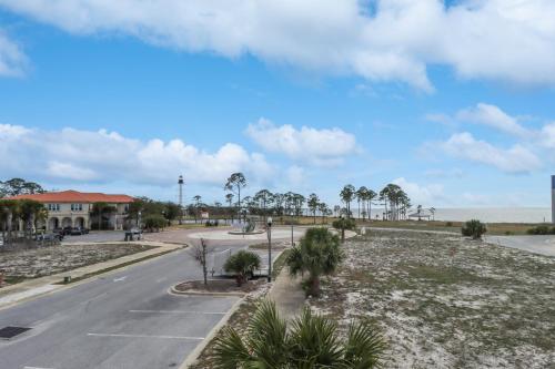an empty street with palm trees and a building at Gin Fizz by Pristine Properties Vacation Rentals in Port Saint Joe