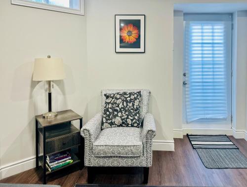 a living room with a chair and a lamp at Spacious 2 Bedroom 1 bath Mississauga Basement Apartment in Mississauga