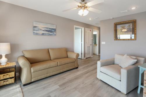 a living room with a couch and a chair at Pearly Shells by Pristine Properties Vacation Rentals in Saint Joe Beach