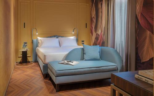 a hotel room with a bed and a chair at WorldHotel Casati 18 in Milan