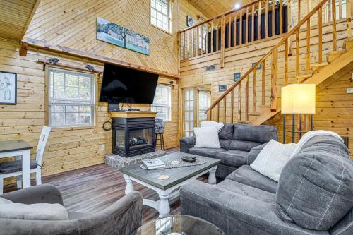 a living room with a fireplace in a log cabin at Tennessee Mountain Cabin about 18 Mi to Knoxville! in Kodak