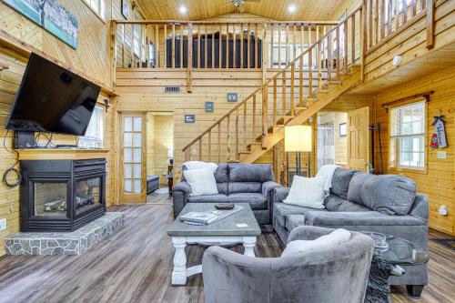 a living room with couches and a tv and a fireplace at Tennessee Mountain Cabin about 18 Mi to Knoxville! in Kodak