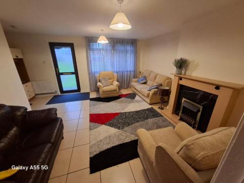 a living room with a couch and a fireplace at Gala House in Lurgan
