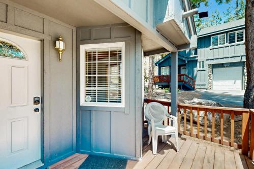 a porch with a white chair and a door at Little Pinecone Retreat in Truckee