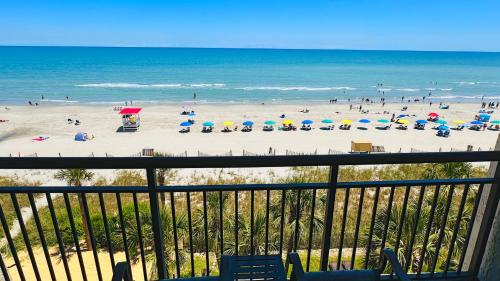 a view of a beach with umbrellas and the ocean at Ocean Reef- Unique Oceanfront Condo-Free parking - Amazing pools in Myrtle Beach