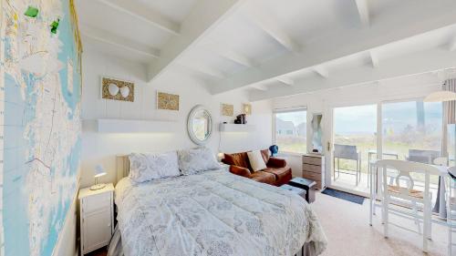 a bedroom with a bed and a map on the wall at Ocean Breeze Retreat in North Truro