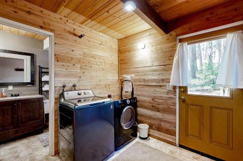a washer and dryer in a room with wooden walls at The Venado House in Arnold