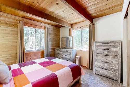 a bedroom with a bed in a room with wooden walls at The Venado House in Arnold
