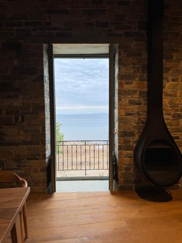 a room with a large window with a view of the ocean at EJ Boutique Suites in Milina
