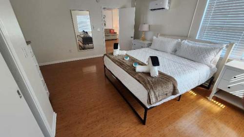 a bedroom with a large bed with a wooden floor at By the Beach Rentals in Clearwater Beach