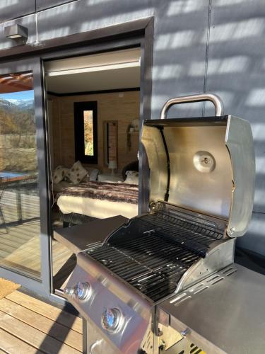 a kitchen with a grill with a view of a bedroom at Tiny House 2 a 3 per Malalcahuello Wifi Satelital in Malalcahuello