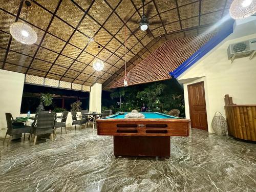 a pool table in the middle of a room at Bamboo Paradise Beach Resort in Argao