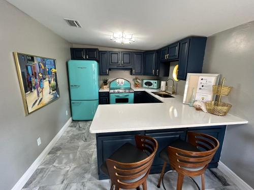 a kitchen with blue cabinets and a white counter top at Stylish Bungalow Near Dining, Parks & Entertainment in Jacksonville