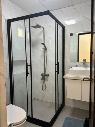 a bathroom with a shower and a toilet and a sink at Vista De Montana Private House in Nasugbu