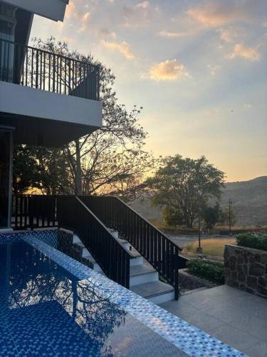 a house with a swimming pool next to a building at Vista De Montana Private House in Nasugbu