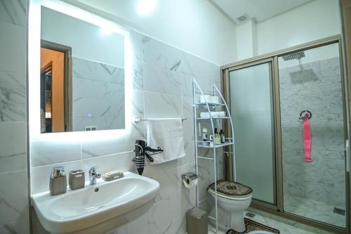 a bathroom with a sink and a toilet and a shower at The Skyline Stay in Marrakech