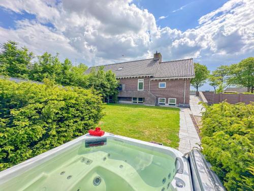 a hot tub in the backyard of a house at Weidezicht in Odiliapeel