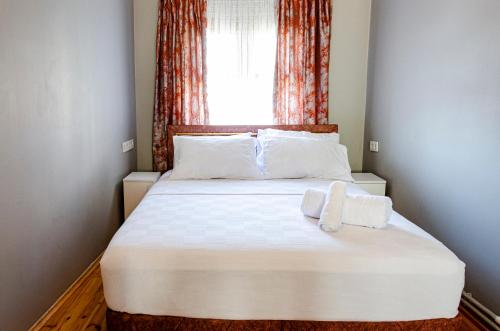 a bedroom with a large white bed with a window at The Wall Private Mansion Kumkapı in Istanbul