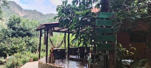 a bunch of signs on a pole in a garden at Mirador Jungle El Macuti in Rurrenabaque