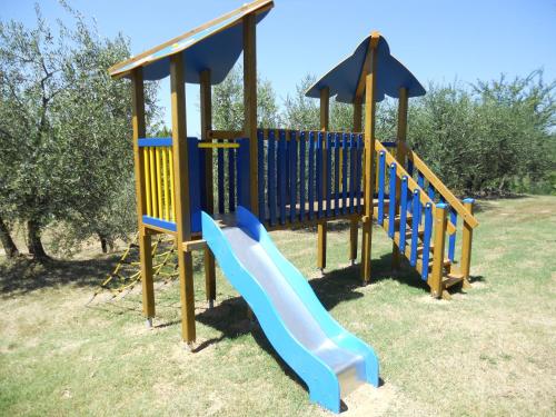 a playground with a slide in a park at La Scuola Di Furio Apartments in Fucecchio