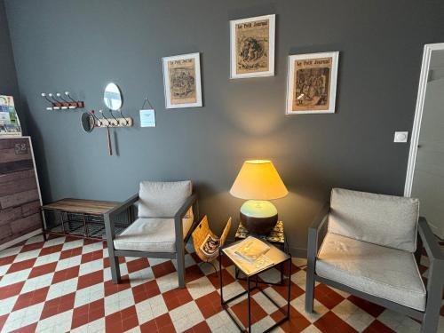 a living room with two chairs and a table and a lamp at Maison de charme rénovée avec piscine, spa et proximité des plages vendéennes - FR-1-426-464 in La Garnache
