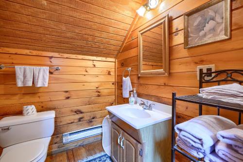 a bathroom with a toilet and a sink in a log cabin at Blue Rose Cabins - Country Cottage in Logan