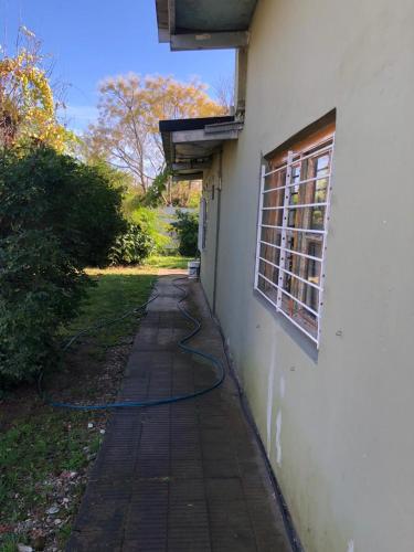 a hose is attached to the side of a building at Druzina in General Belgrano