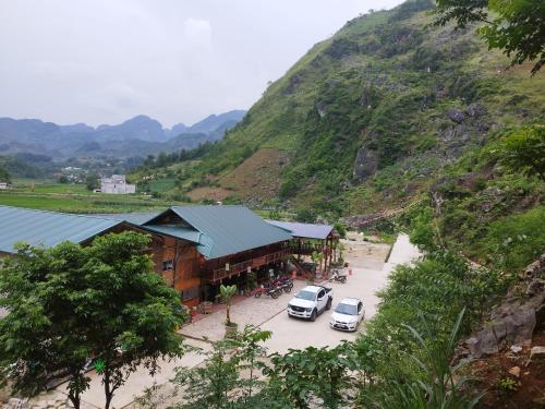 a car parked in a parking lot next to a mountain at Homestay Tommy House in Ha Giang