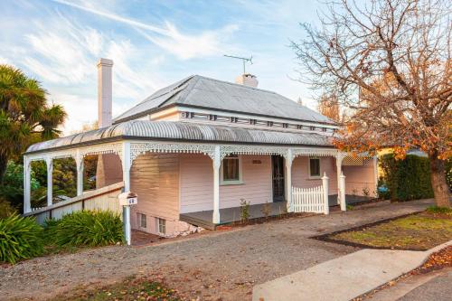 an old white house with a metal roof at Isabellas At Beechworth in Beechworth