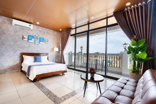 a hotel room with a bed and a couch at CAMY Hotel Vung Tau in Vung Tau