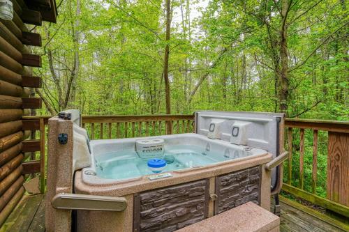 a hot tub on the deck of a house at Blue Rose Cabins - Lovebirds Cabin in Logan