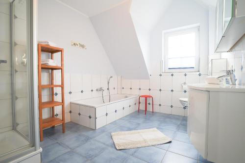 a bathroom with a tub and a sink at Hof Köhne - Forsthaus 3er in Schmallenberg