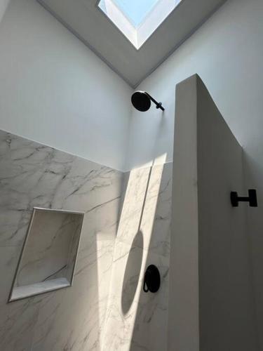 a white room with a skylight and a mirror at Casa Palmera Privada in Girardot