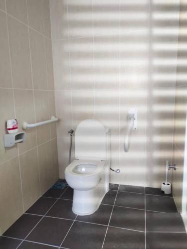 a bathroom with a white toilet in a stall at Homestay Ijan in Cyberjaya