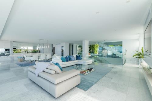 a living room with two couches and a table at Azure in Sunshine Beach