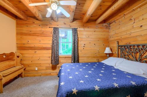 a bedroom with a bed in a log cabin at Blue Rose Cabins - Oleander Cabin in Logan