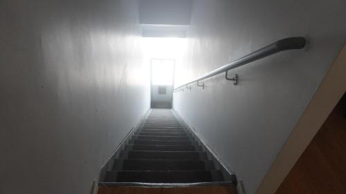 a stairway with a light at the top of a stair case at HoMa Homestay Hotel by Olympic Stadium Montreal Auberge-Hostel in Montréal