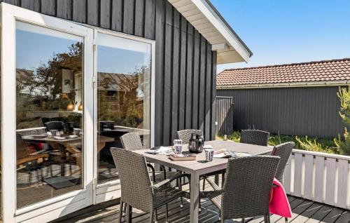 a patio with a table and chairs on a deck at Gorgeous Home In Thisted With Wifi in Thisted