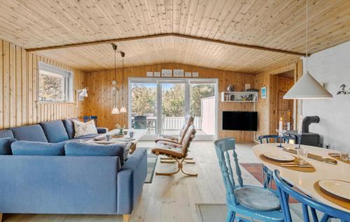 a living room with a blue couch and a table at Gorgeous Home In Thisted With Wifi in Thisted