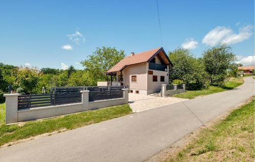 a house with a fence on the side of a road at 2 Bedroom Cozy Home In Kobasicari in Kobasičari