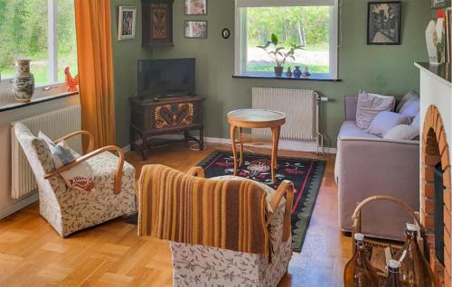 a living room with a couch and a table at Stunning Home In Leksand With Kitchen in Leksand