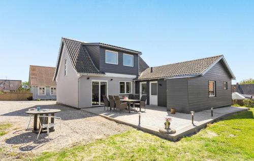 a house with a patio and a table at 3 Bedroom Pet Friendly Home In Bagenkop in Bagenkop