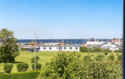 a white building with the ocean in the background at 3 Bedroom Pet Friendly Home In Bagenkop in Bagenkop