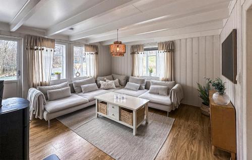 a living room with a couch and a table at 3 Bedroom Stunning Home In Vikebygd in Vikebygd