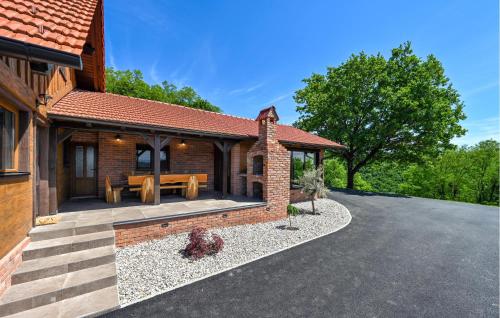 a brick house with a patio with a picnic table at 3 Bedroom Stunning Home In Mace in Mače