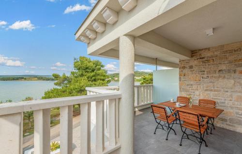 un balcone con tavolo e sedie e vista sull'acqua di Awesome Apartment In Mrljane a Mrljane